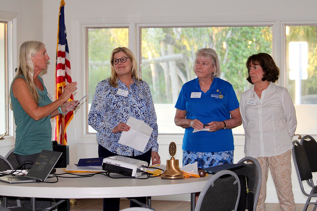 Rotary Club of Longboat Key President Terri Driver presents awards to members Ellen Greenberger, Carol Erker and Belinda Bauer for not only contributing their hours, but also offering financial support to the Rotary's mission over the years. Driver presented the awards at their Jan. 6 meeting, which featured guest speaker Charlie Mopps from Public Works.