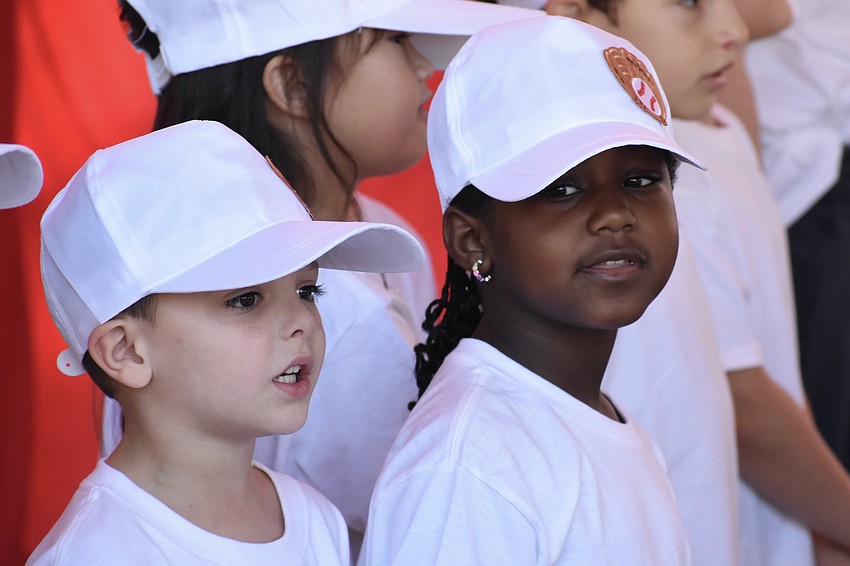 Kindergarteners Tommy Herrera-Dente and Ada Goita sing 