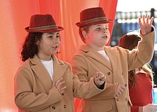 Third graders Silas Swor and Misha Reus perform in "Button Up Your Overcoat," celebrating the 1930s.