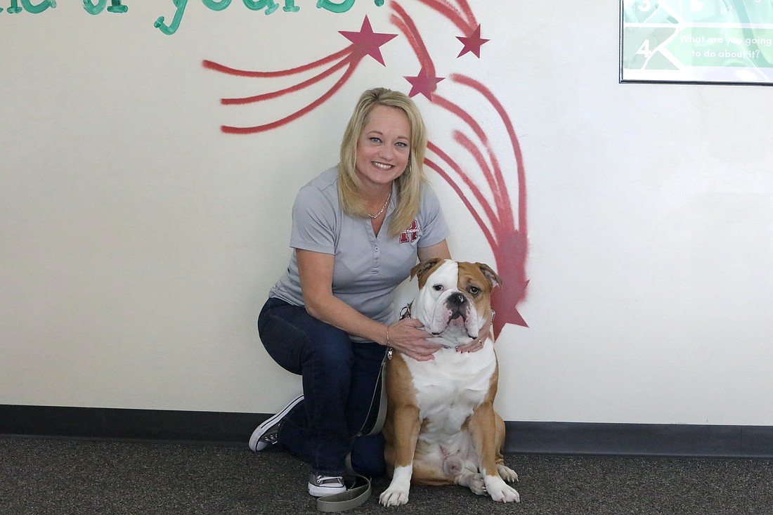 Flagler Schools Assistant Principal of the Year Abra Seay with Champ. Photo by Brent Woronoff