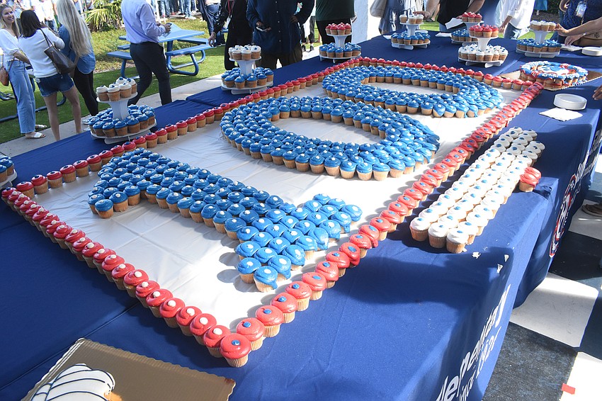 Cupcakes are arranged in a display celebrating 100 years.