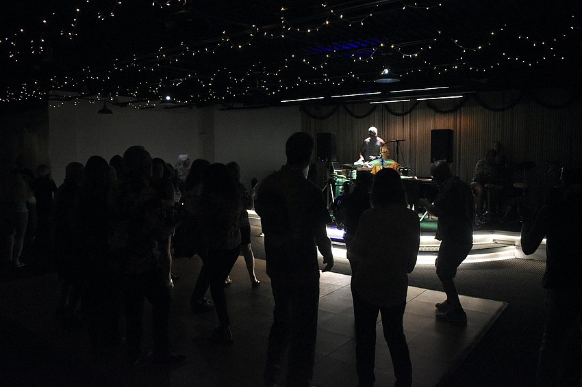 Attendees dance to the music.