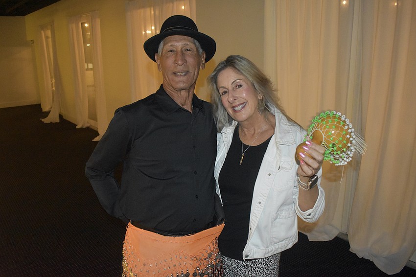 Ron Muratti and Linda Petroski get into a tropical spirit.