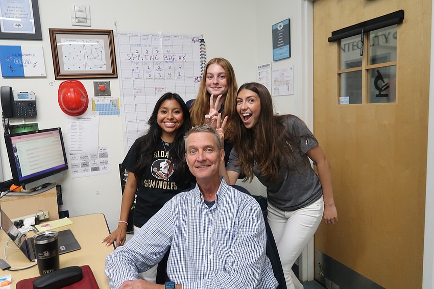The Out-of-Door Academy students Audrey Sugamura, Baylie McKenna and Mia Rosenthal pose with science teacher Mike Newhams last May.