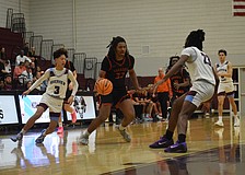 Senior forward David Young (33) dribbles up the court with two defenders on him during a Jan. 9 game between Sarasota and Riverview. The Sailors have leaned on Young, among others, with Johnny Lackaff unavailable.