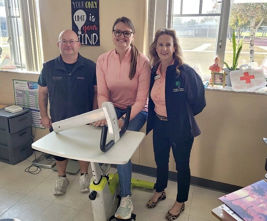 Indian Trails Middle School Teacher of the Year Shannon Russell (center), who teaches Health and Wellness and PE, shows off the new addition to her classroom. Courtesy photo