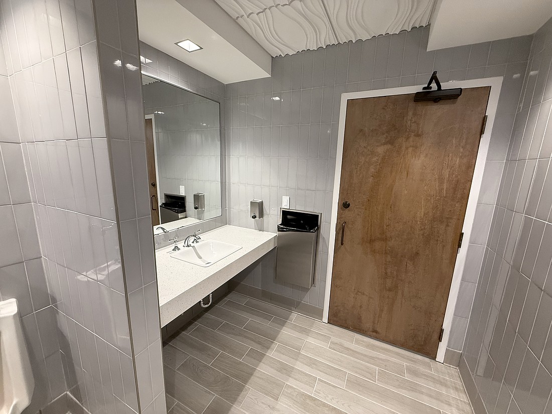 The interior of the new restrooms at Sarasota City Hall feature tile walls and an architectural feature on the ceilings.