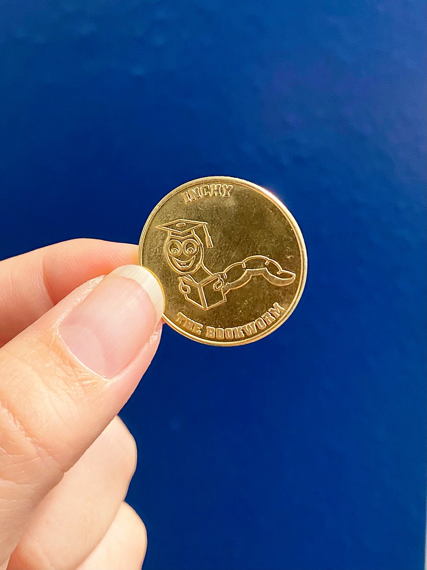 Students at Alta Vista Elementary School can use these tokens to get a free book from the new vending machine installed courtesy of the Sarasota Yacht Club youth board.