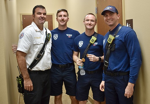 The crew from Station 1 walk across the parking lot to grab some lunch. From left to right: Battalion Chief Craig Madsen and firefighters Adam Stem, Evan Berggren and Tyler Schuele.