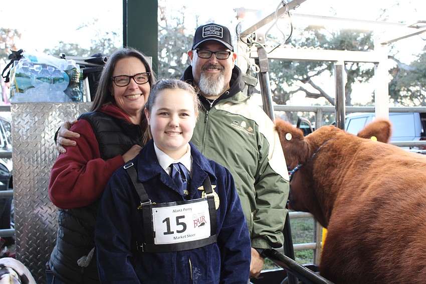 Lakewood Ranch High School freshman Alana Perry is supported by her parents Angela and Scott Perry while preparing to show her chianina cross named 