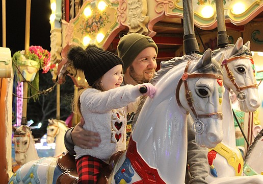 Bradenton's Harley Busch, 3, is eager to ride the carousel alongside her father John Busch at the Manatee County Fair. She also rode a camel moments before.