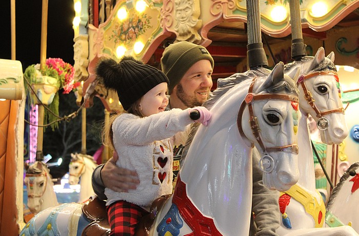 Bradenton's Harley Busch, 3, is eager to ride the carousel alongside her father John Busch at the Manatee County Fair. She also rode a camel moments before.