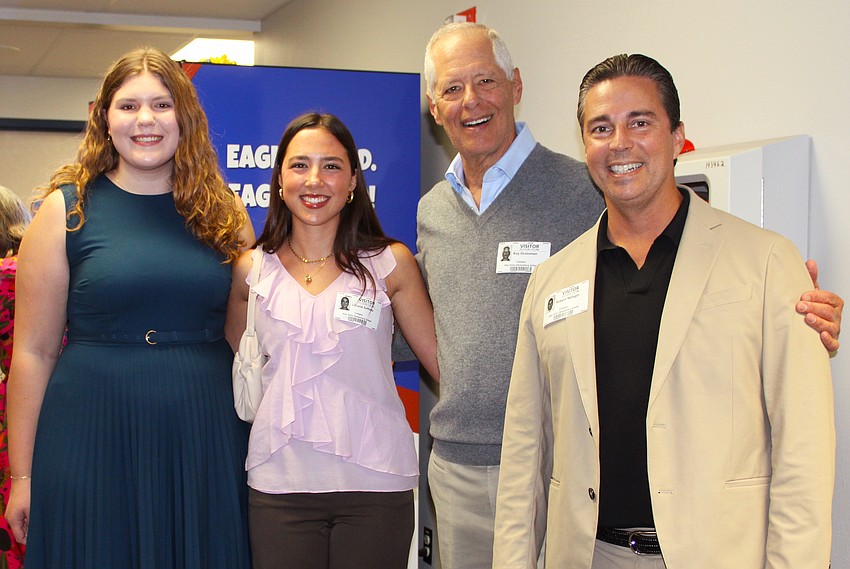 Sarasota Yacht Club's Junior Commander Calista Ream, Junior Secretary Lilliana Sultana, SYC Cares board member Roy Grossman and Commodore Robert Milligan joined in the celebration of the book vending machine unveiling.