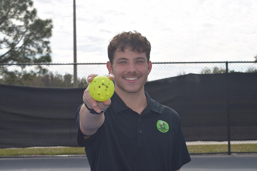 Dillon Rosenthal holds a fully-recycled pickleball from his first test batch. On Jan. 14, he asked a group of players at Lakewood Ranch Park to try it out, and plans on rolling them out to as many of his partners as possible.