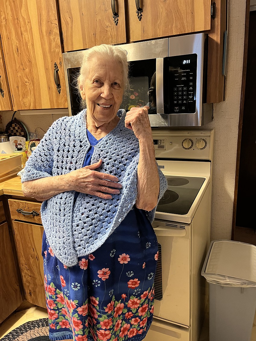 Veda Flick poses in front of the microwave Council on Aging installed for her. Courtesy photo