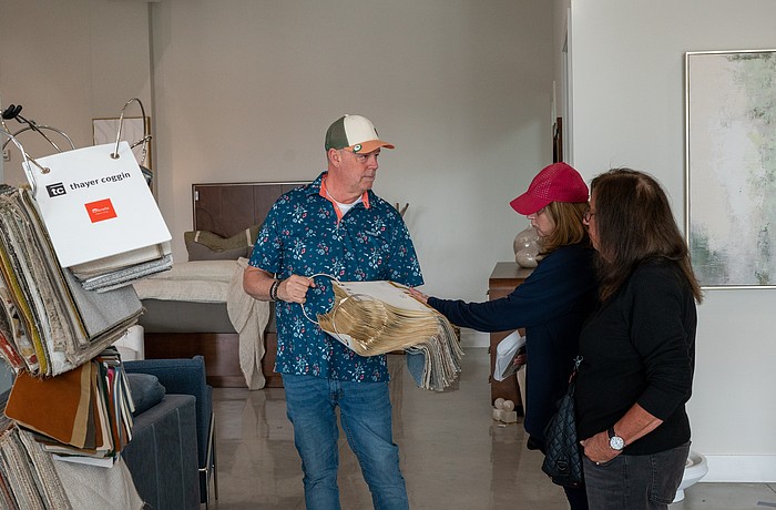 Couch LBK co-owner Ken Rushing shows a pair of shoppers a fabric sample inside the furniture showroom at Brista Commons Wednesday, Jan. 14.