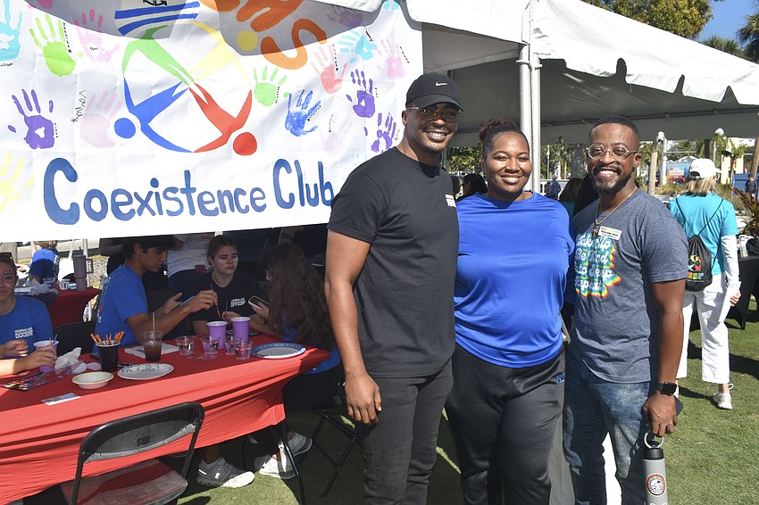 Dr. Sherika Evans and LaMichael Leonard Jr., advisors for Booker High School's Coexistence Club, which is part of a series of student-driven service clubs by Embracing Our Differences, pose with Patrick Arthur Jackson, vice president of learning and engagement with Embracing Our Differences.