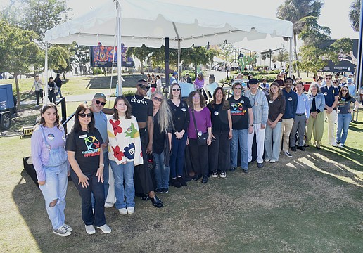 Artists from Embracing Our Differences line up to be recognized alongside President and CEO Sarah Wertheimer (right).