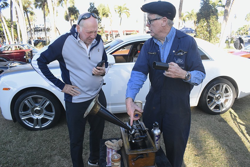 Mark Rosenthal learns about a phonograph from Tom Shults, who co-owns a 1926 Fort Model T Runabout with his wife Debbie Shults.