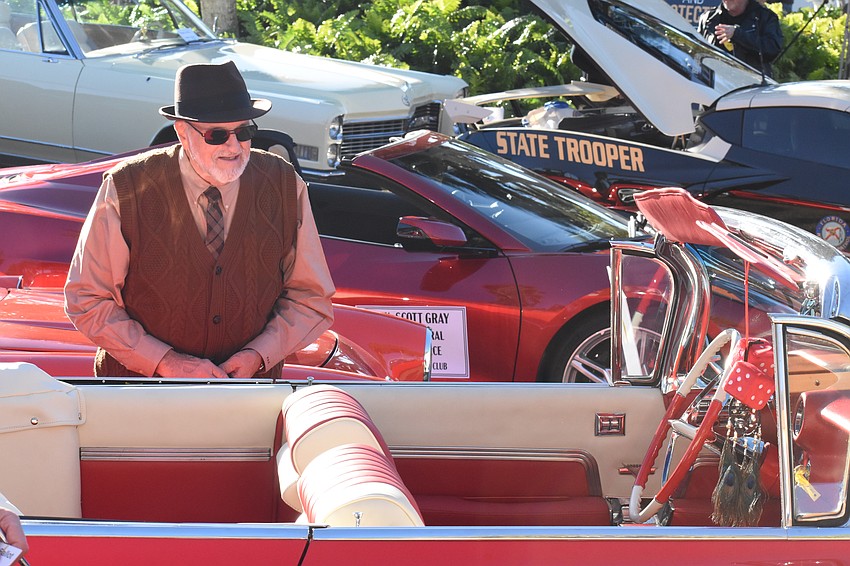 Phil Annunziato looks over his 1959 Cadillac Series 62 Convertible, 