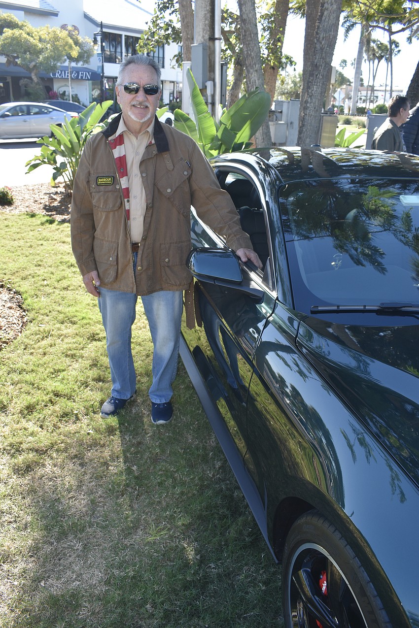 Greg Moisan posse with a custom-made car modeled after the modified 1968 Ford Mustang Fastback driven by Steve McQueen in the film 