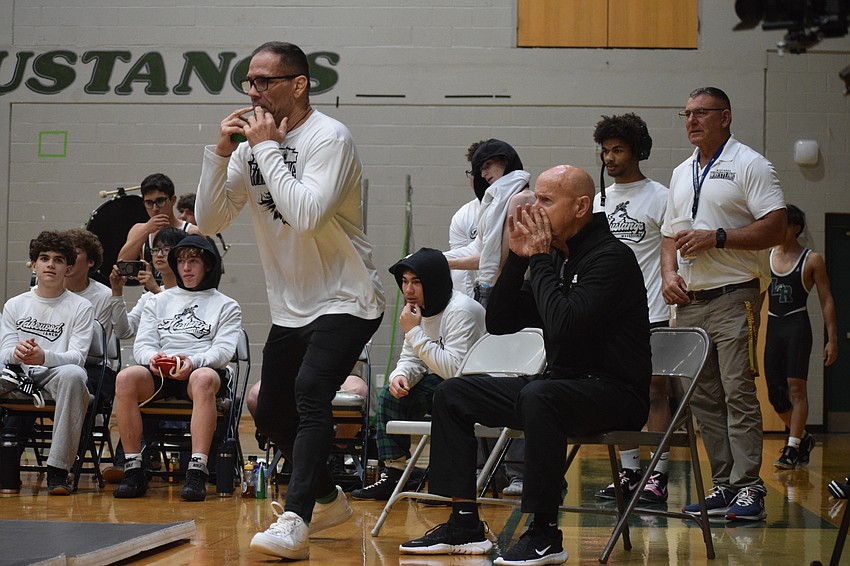 Assistant Mike Schyck (left) and coach Pat Ancil (right) bellow commands to their Lakewood Ranch boys wrestlers against Riverview.