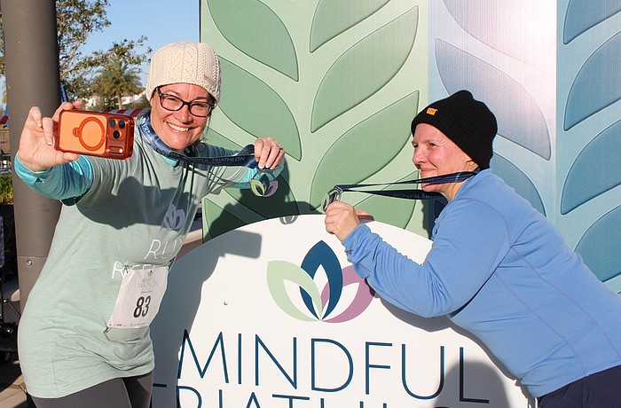 Lakewood Ranch's Rhonda Leiberick and Roscelyn Guenther snag a selfie together in between the running and yoga portions of the triathlon. They alternated between walking and running every two minutes.