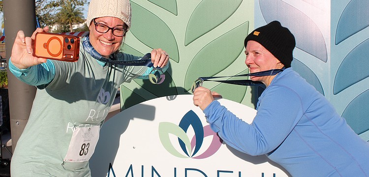 Lakewood Ranch's Rhonda Leiberick and Roscelyn Guenther snag a selfie together in between the running and yoga portions of the triathlon. They alternated between walking and running every two minutes.
