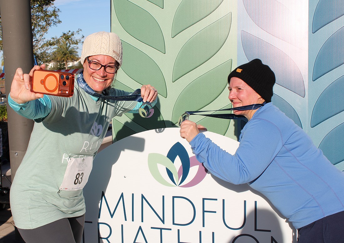 Lakewood Ranch's Rhonda Leiberick and Roscelyn Guenther snag a selfie together in between the running and yoga portions of the triathlon. They alternated between walking and running every two minutes.
