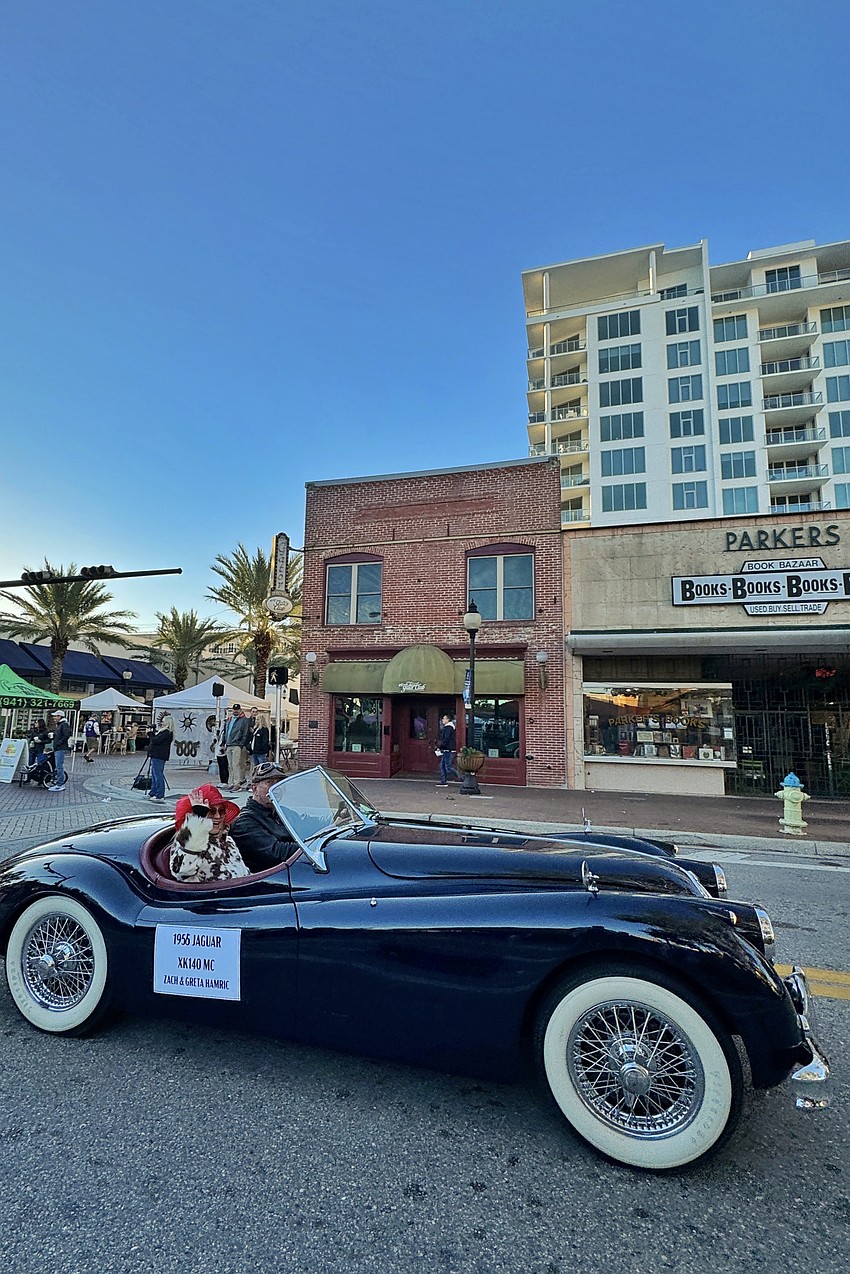 A 1956 Jaguar XK140 MC owned by Zach and Greta Hamric, which was previously owned by Michael Douglas and Catherine Zeta-Jones, makes its way along the parade route.