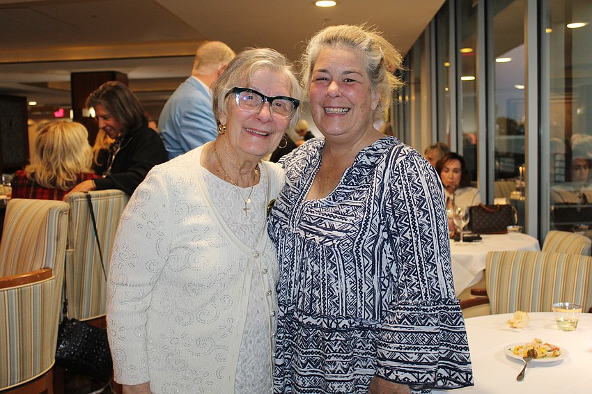Mother-daughter duo Cheryl and Kimmy Mooney sample the seafood offerings at the Plymouth Harbor on Sarasota Bay anniversary kick-off.
