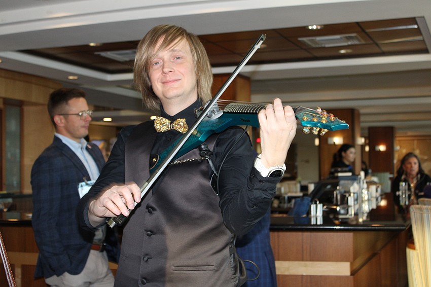 Musician Jason Clark plays the electric violin.
