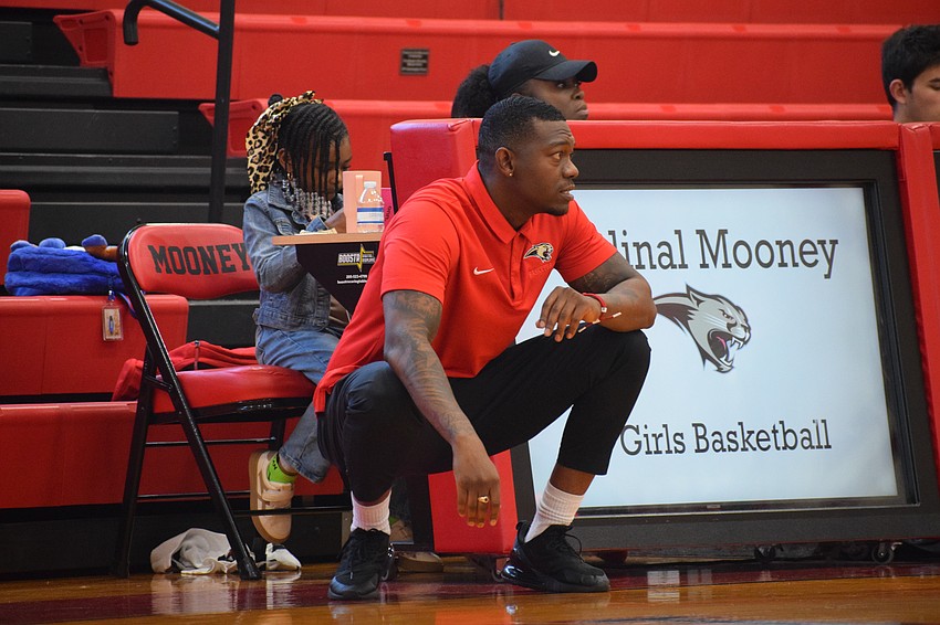 Cortney Sawyer watches the Cougars on the offensive end during their Jan. 17 game against the Buffaloes. In his first season as coach, the former assistant has Cardinal Mooney at 11-9 with five games remaining in the regular season.