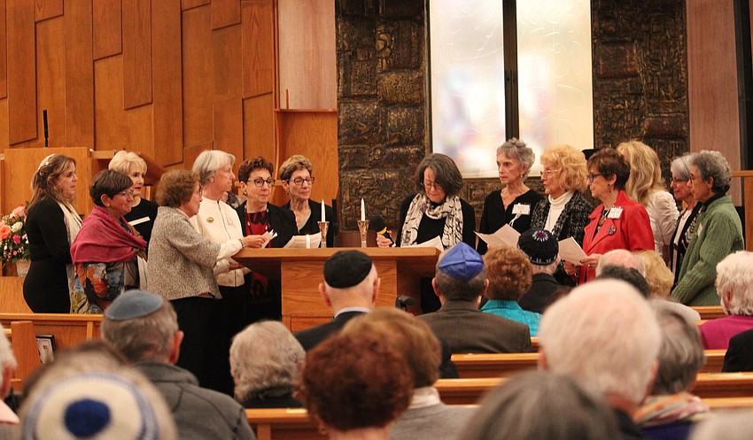 Members of the Temple Beth Israel Social Action Committee light a set of candles in remembrance of Martin Luther King Jr.