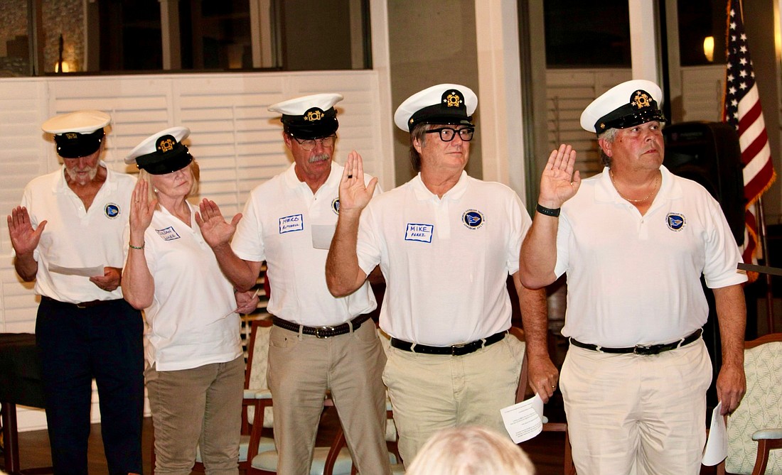 Leaders from the Longboat Harbour Yacht Club participate in the swearing-in ceremony during the Jan. 17 Change of Watch. From left, John Shea, dockmaster; Susan Luke, purser; Herb Ritchell, scribe; Mike Perez, vice commodore; and Jeff Hecklau, commodore.