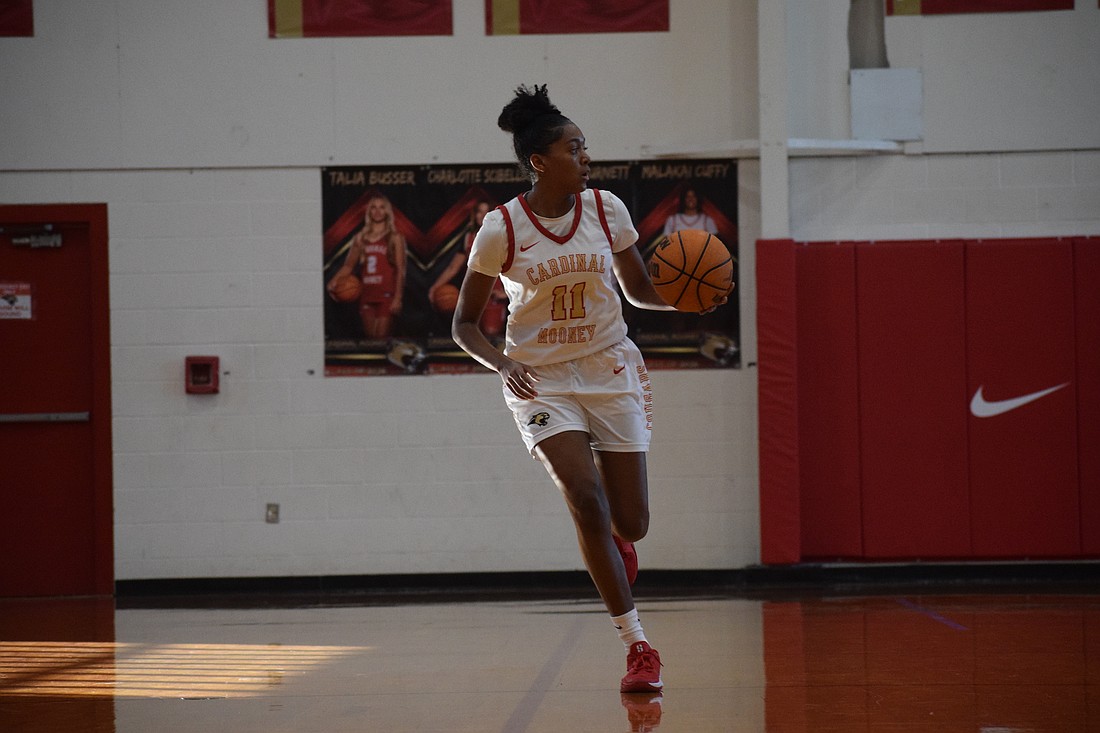 Junior guard Jadyn Watts takes the ball downcourt for Cardinal Mooney girls basketball during a Jan. 17 game against The Villages Charter. After transferring from Sickles, she has been a top scorer amid an up-and-down season for the Cougars.