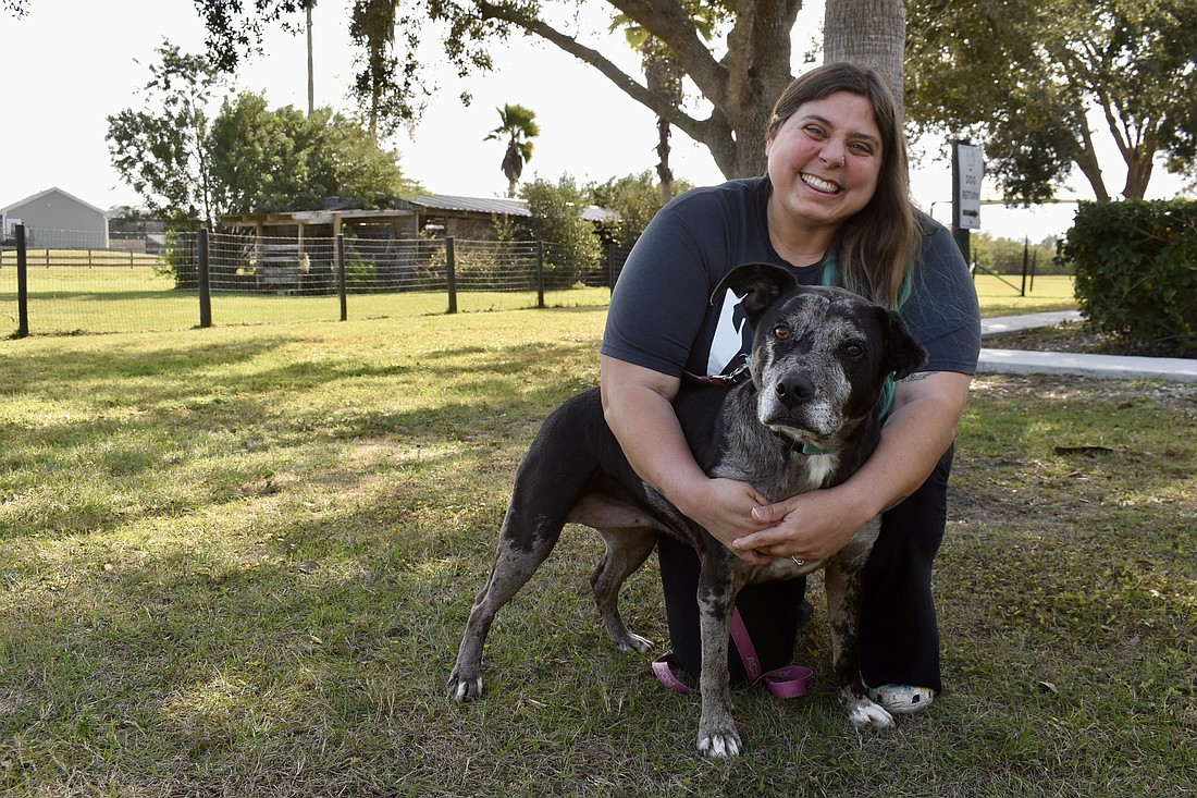 Danielle Ziegler is the shelter director. She's cuddling with Lyza, a 9-year-old Catahoula mix with chronic ear infections.