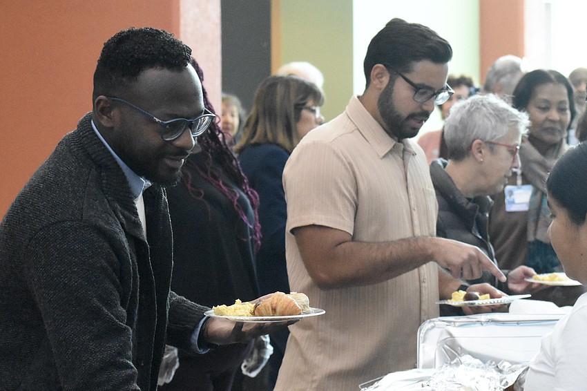 Jammal Marcano and Gustavo Ramos prepare to enjoy breakfast.