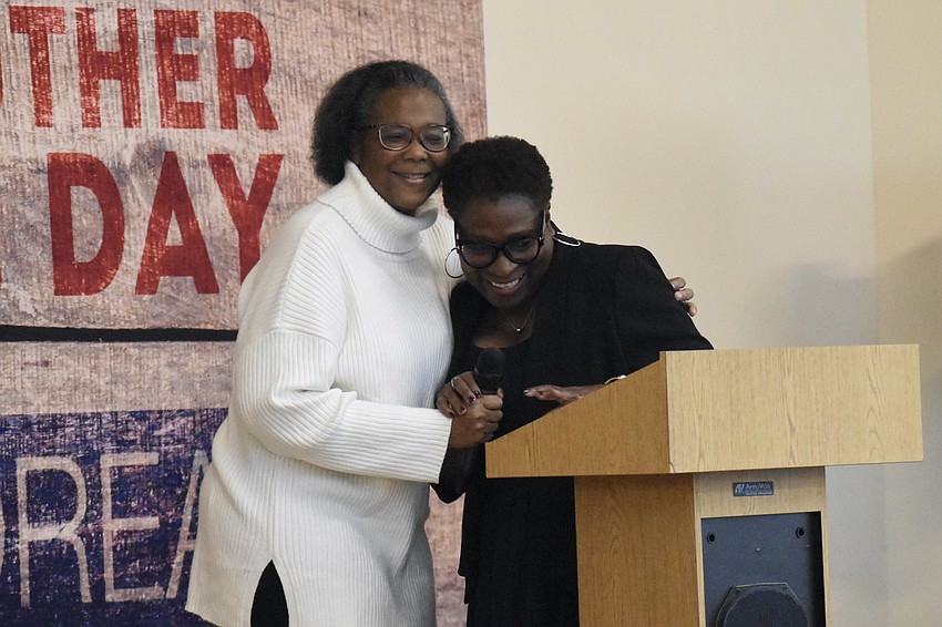 Bel Feltner greets Monica Donley, the founder of Sisters Sowing Seeds, who was honored for community service.