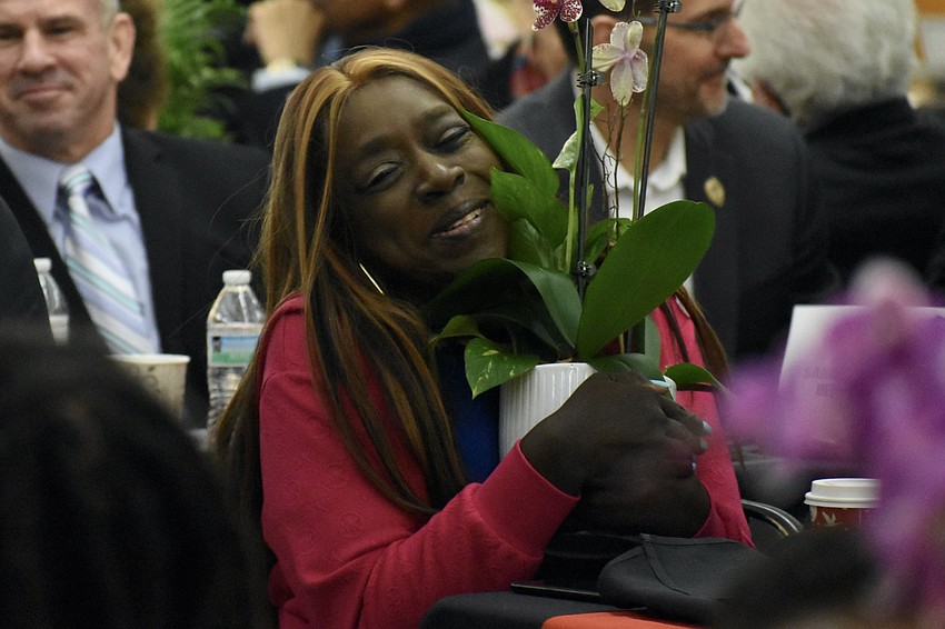 After the plant at each table was offered to the oldest guest last year, this year, they were offered to the youngest. Mary Burton, an advocate for Sarasota Medical Pregnancy Center's mobile unit, claims her plant.