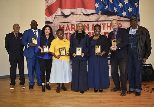 Sarasota MLK Celebration Committee Chair Jetson Grimes, awardees Joseph Mack, Susan Imperato, Valerie Buchand, Meadow Lark Walker, Monica Donley and David Morse, and former mayor Willie Shaw, gather on stage.