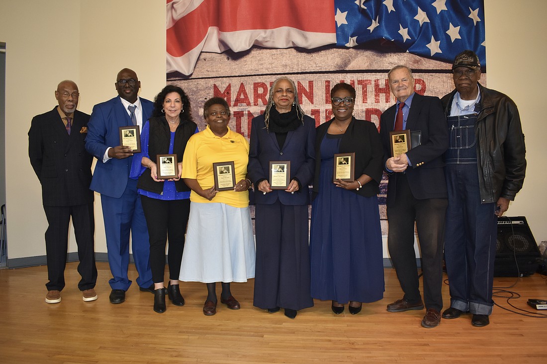 Sarasota MLK Celebration Committee Chair Jetson Grimes, awardees Joseph Mack, Susan Imperato, Valerie Buchand, Meadow Lark Walker, Monica Donley and David Morse, and former mayor Willie Shaw, gather on stage.