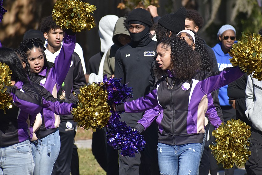 Cheerleaders from Booker High School make their way along the parade route.