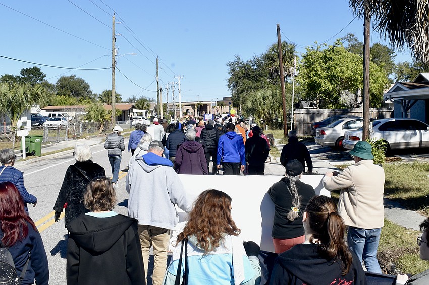 The parade approaches Booker High School.