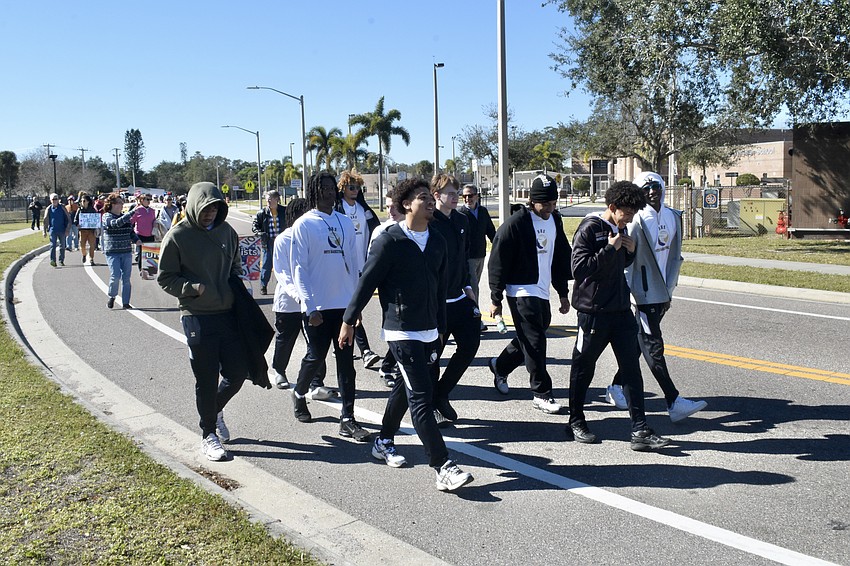 Students from Booker High School's basketball team make their way along the parade route.