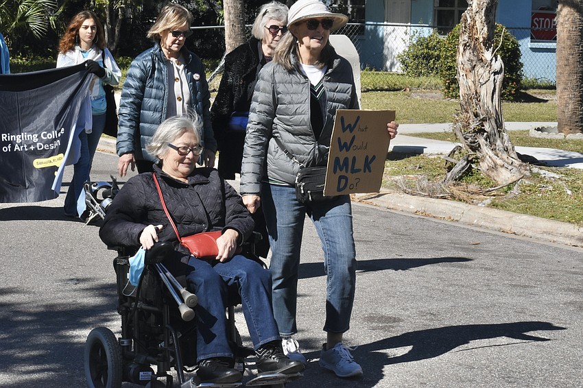 Participants including Christine Evans and Rozie Zeck (front) make their way along the parade route.