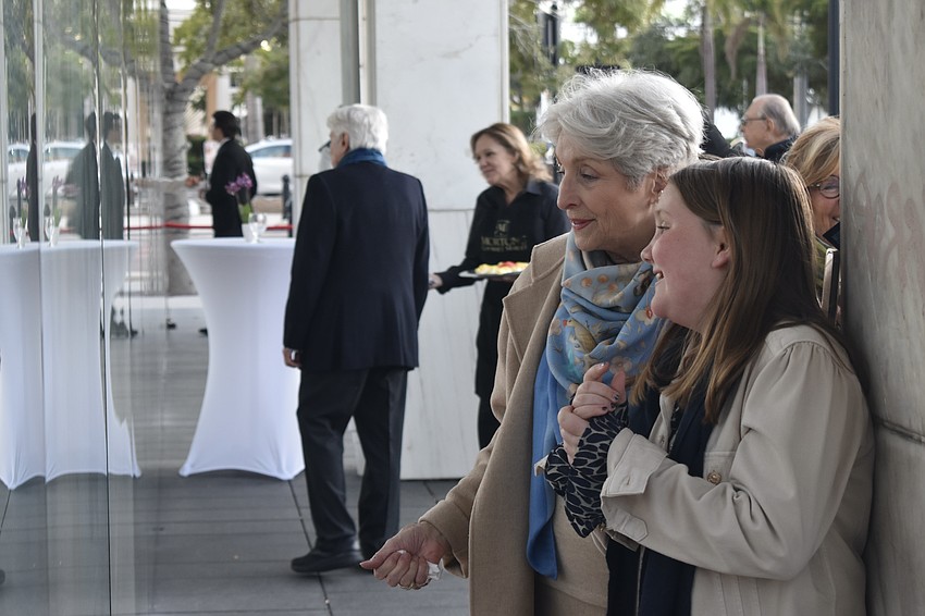 Michael Saunders looks at the display with her granddaughter Kinsley Saunders, 9.