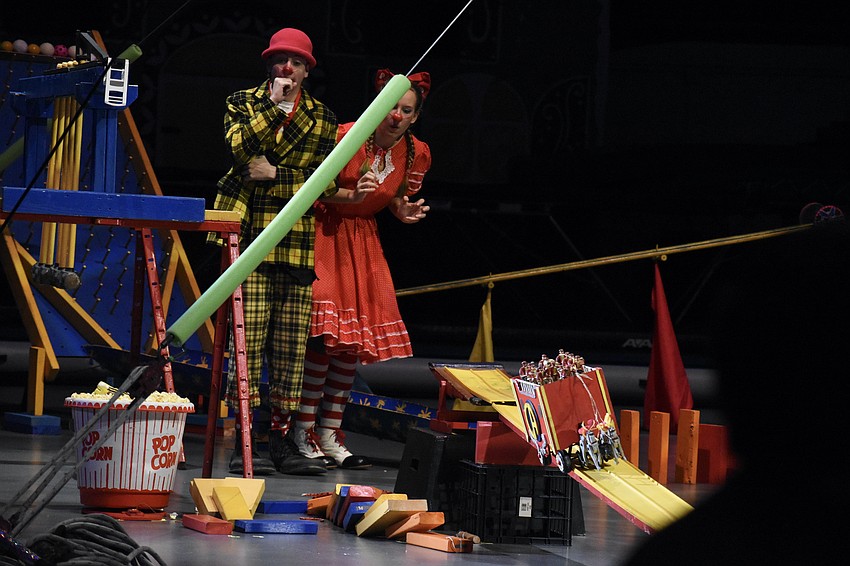 Kepler Henry and Sara Catalano activate a contraption and demonstrate cause and effect.