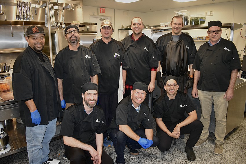 A team gathers in the kitchen. Front row: Chef Instructor Benjamin Burnside, Michael Silverman and Diago Peguero. Back row: Ivan Alonso, Spencer Lucas, Kevin Geyer, Brent Jephson, Andrew Cavazzi and Jerry Clancy.