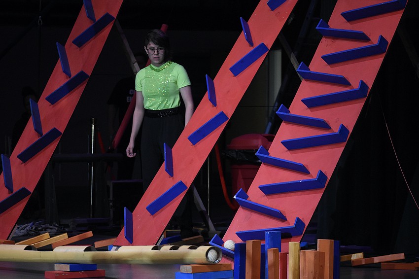 Helena Kushner watches as a contraption does its work.